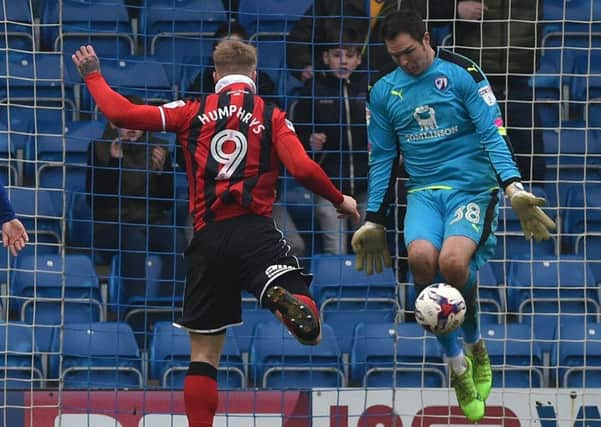 Chesterfield's keeper Thorsten Stuckmann saves a certain goal from Shrewsbury's Stephen Humphrys