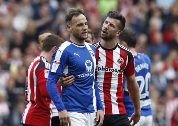 Jake Wright of Sheffield Utd  walks Dan Gardner of Chesterfield after his sending off during the English League One match at  Bramall Lane Stadium, Sheffield. Picture date: April 30th 2017. Pic credit should read: Simon Bellis/Sportimage