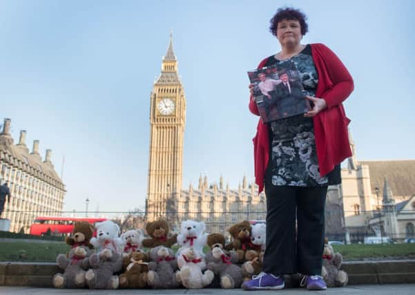 Claire Throssell, whose children were killed by her abusive ex-husband in 2014, lays 20 teddy bears in Westminster symbolising the children who have died as a result of unsafe child contact with a parent who is a perpetrator of domestic abuse, after she delivered a petition to Downing Street. Photo: Stefan Rousseau/PA Wire