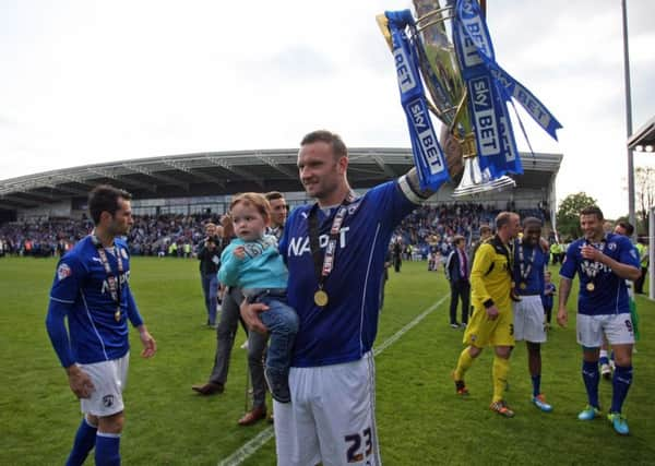 Chesterfield v Fleetwood Town. Players celebrate after Chesterfield won the League 2 Championship. Captain Ian Evatt with the trophy