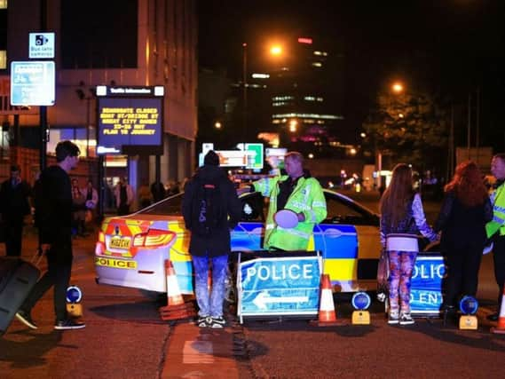 Emergency services at Manchester Arena after reports of an explosion at the venue during an Ariana Grande gig. Peter Byrne/PA Wire