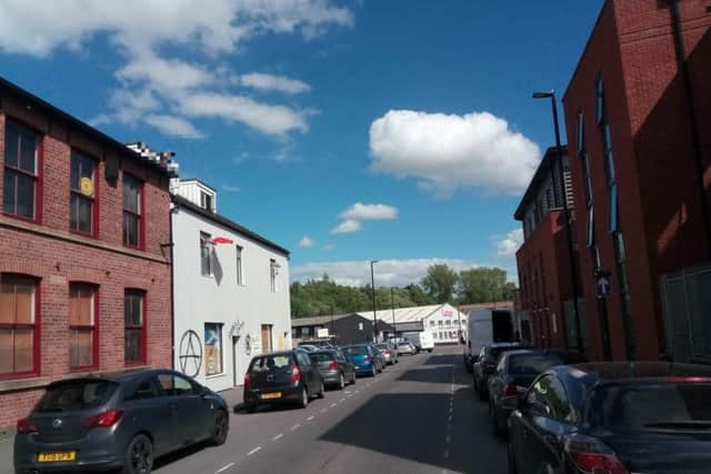 A man on the roof of the property in Kelham Island.