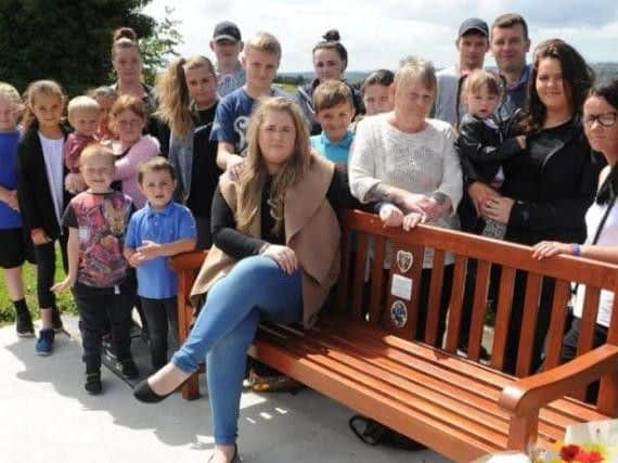 Friends and family gather round a bench in memory of Josh Tyler, who was killed on Mansfield Road, Swallownest. Picture: Andrew Roe