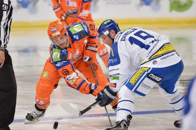 Robert Dowd competes for the puck