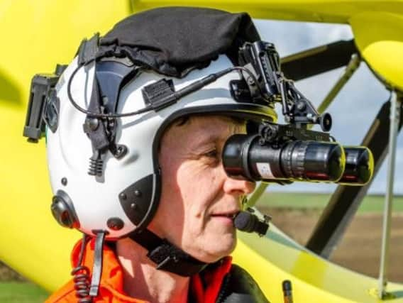 A pilot tries on the night-vision goggles.