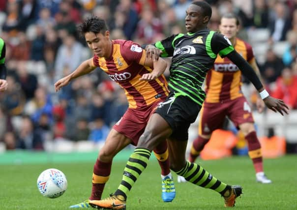 Rovers' star man Rodney Kongolo challenges  Bradford's Adam Chicksen.  Picture Bruce Rollinson