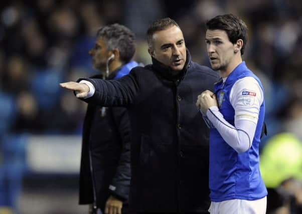 Owls Carlos Carvalhal gives last minute instructions to sub Kieran Lee before coming on against Millwall...Pic Steve Ellis