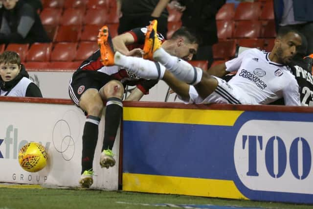 Sheffield United's Chris Basham (left) and Fulham's Denis Odoi take a tumble