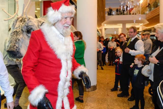 He's behind you! Oh yes he is...Santa leads the reindeer puppets parade