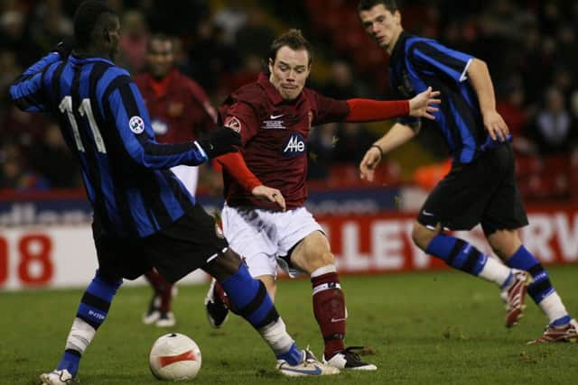 Sheffield FC forward Matt Roney evades Inter Milan's Mario Balotelli