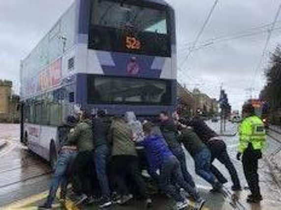 A group of fans who helped to move a broken down bus out of the way of traffic have been praised by police. Picture: Sheffield West NHP