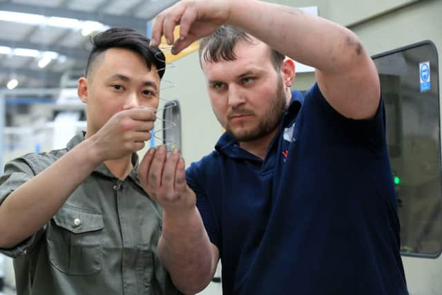 Lin Shanzhou and Ashley Cadmen checking springs.