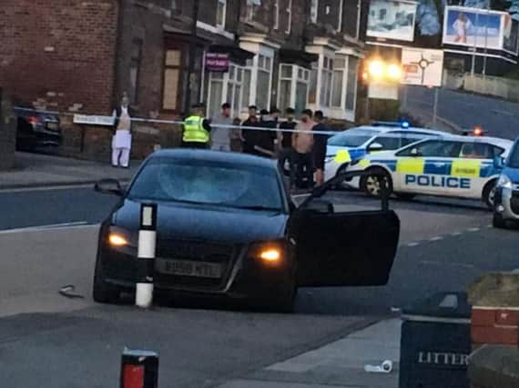 Police officers on Wellgate after a stabbing in Rotherham