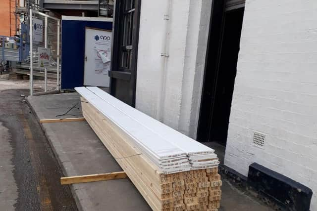 A stack of wood blocking the front door of the restaurant