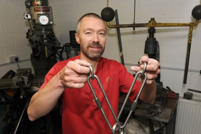 Martin Roberts with titanium anchors for belays and abseiling off.